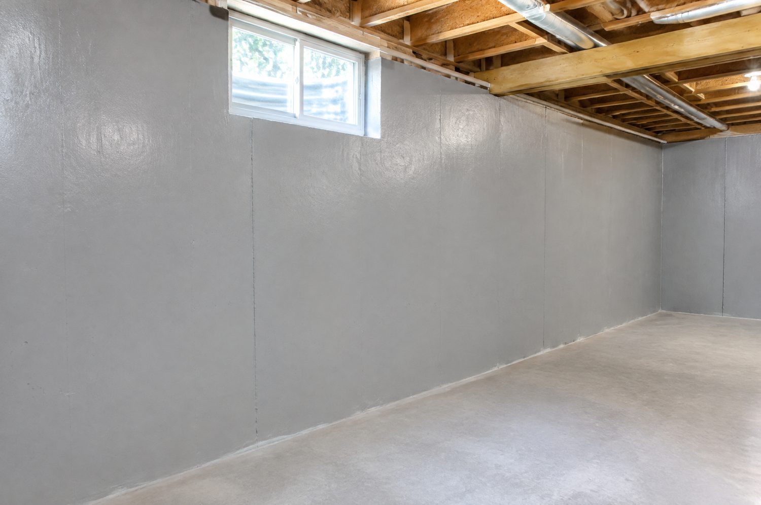 Interior foundation walls coated with waterproof sealer in a Charlotte, NC basement